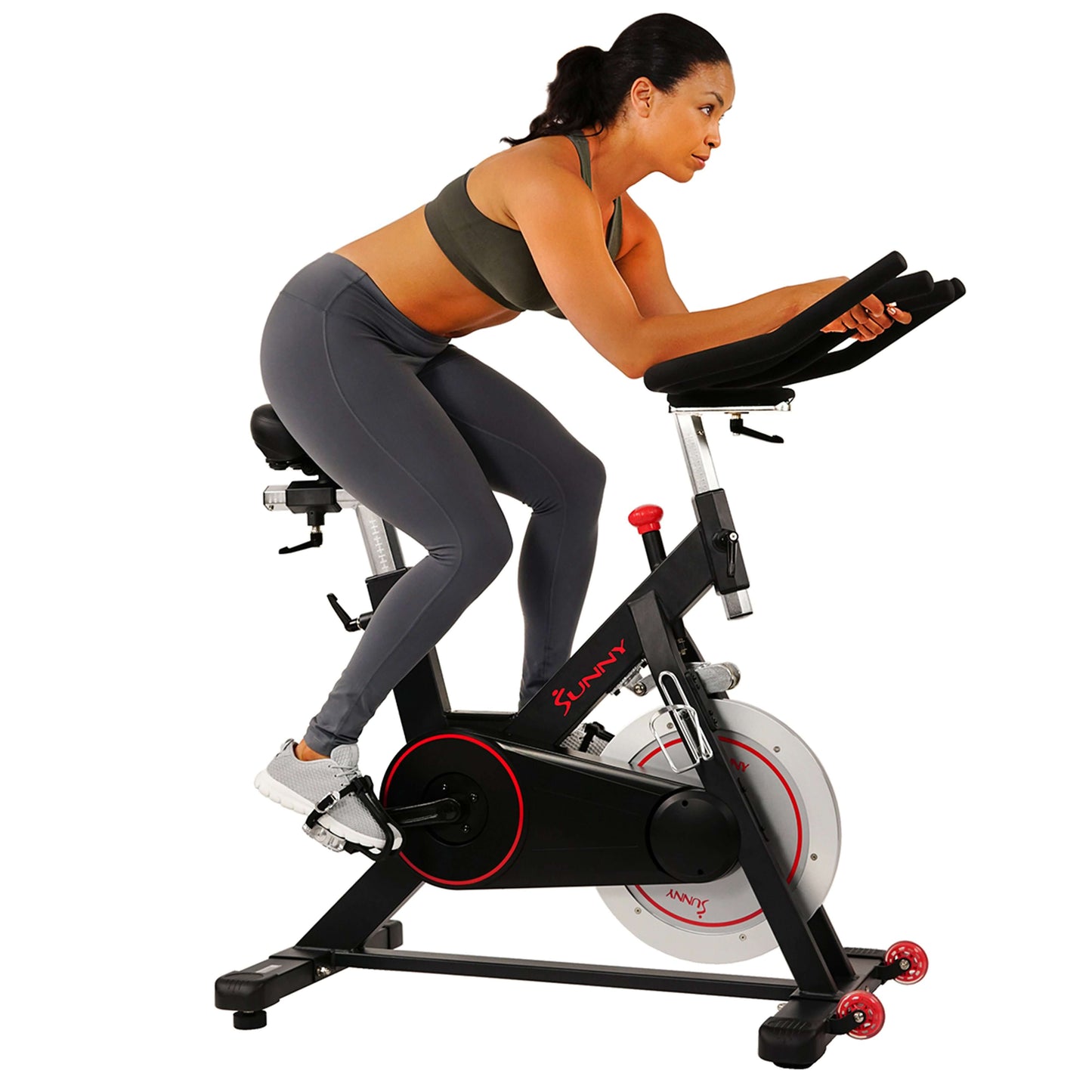 Woman exercising on Sunny Health & Fitness Magnetic Belt Drive Indoor Cycling Bike SF-B1805 with 44 lb Flywheel and Device Holder