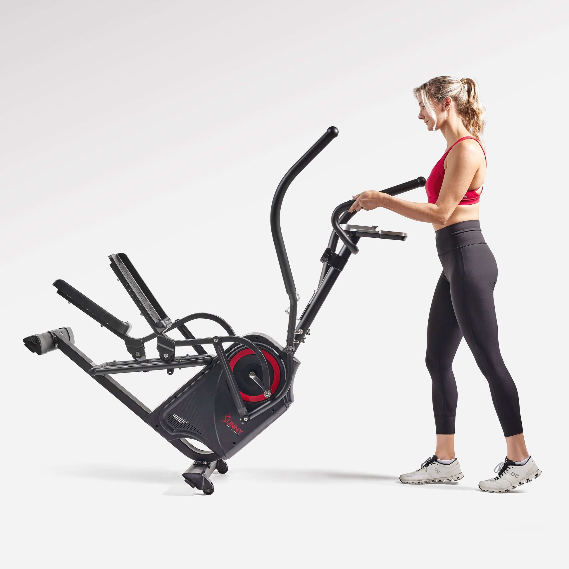 Woman using the Sunny Health & Fitness Premium Cardio Climber SF-E3919 for a full-body workout.